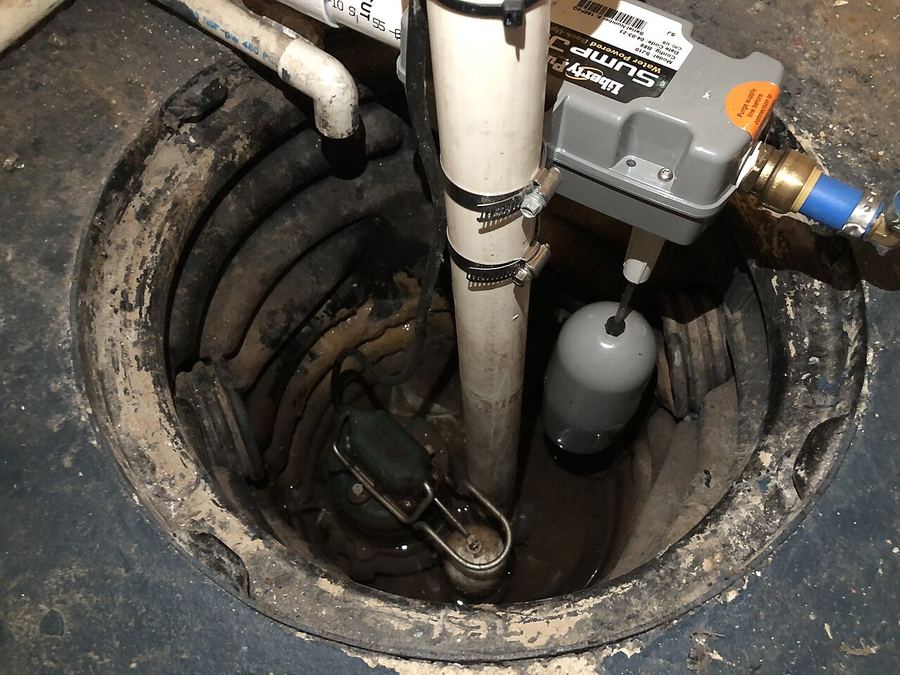 A newly installed sump pump in its basin