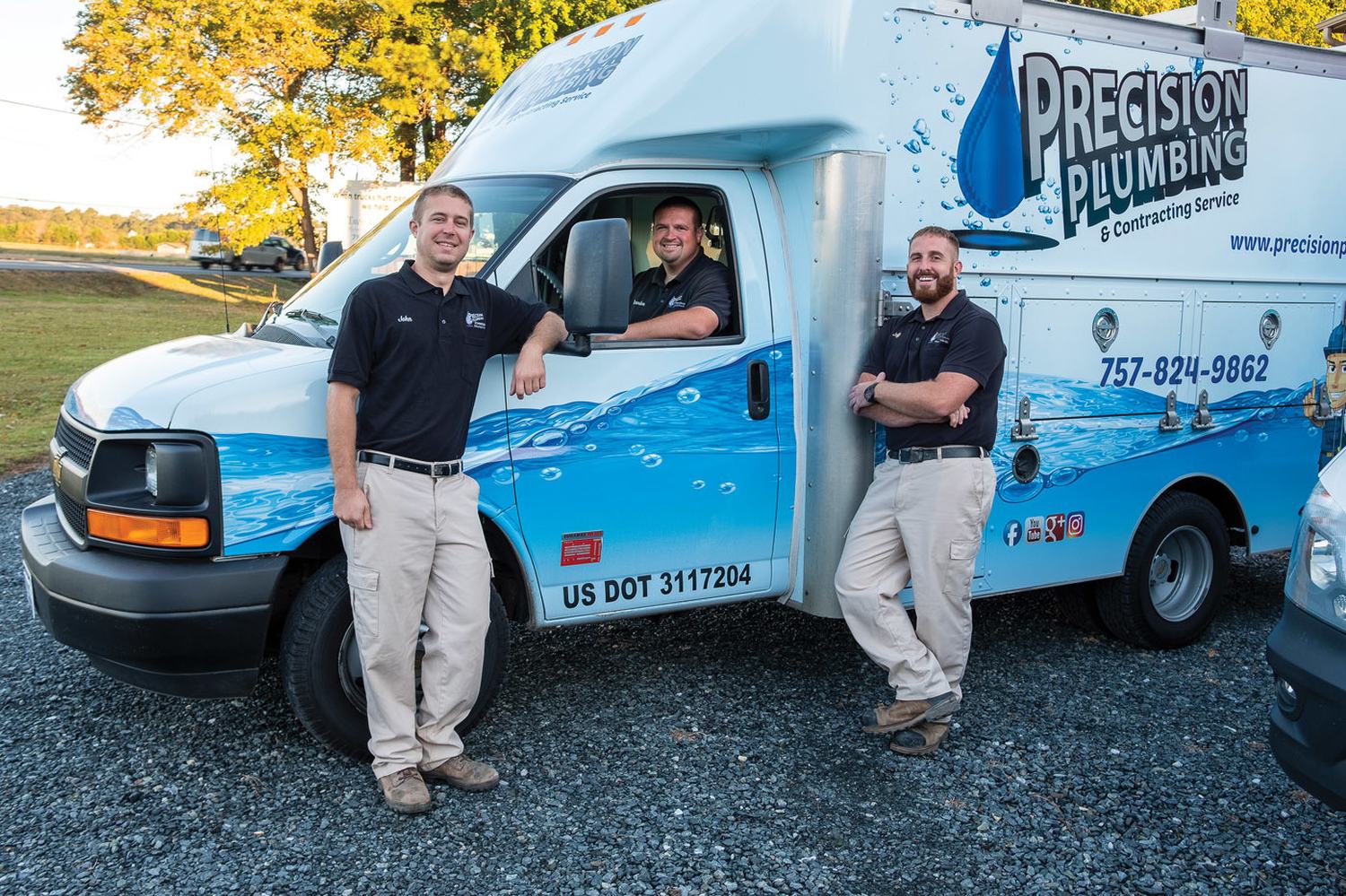 Precision Plumbing technicians with a fully stocked service truck